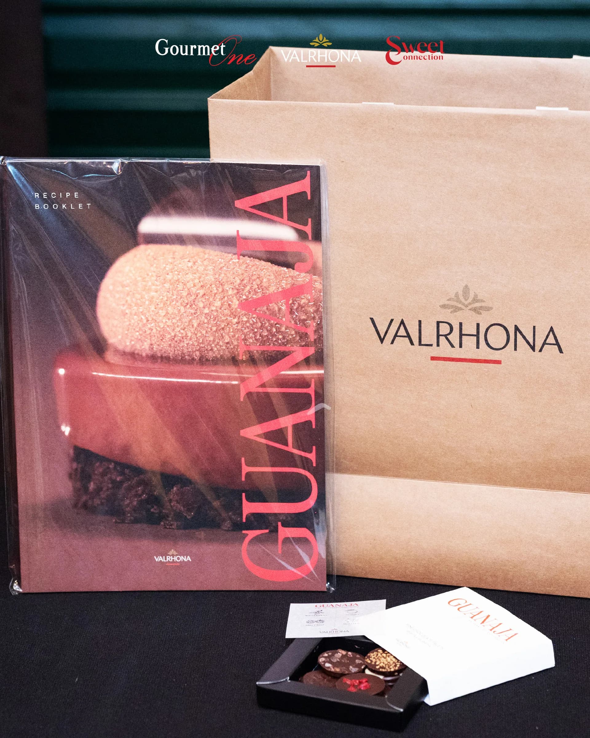 Guanaja anniversary gifts and Valrhona packaging displayed at the event.
